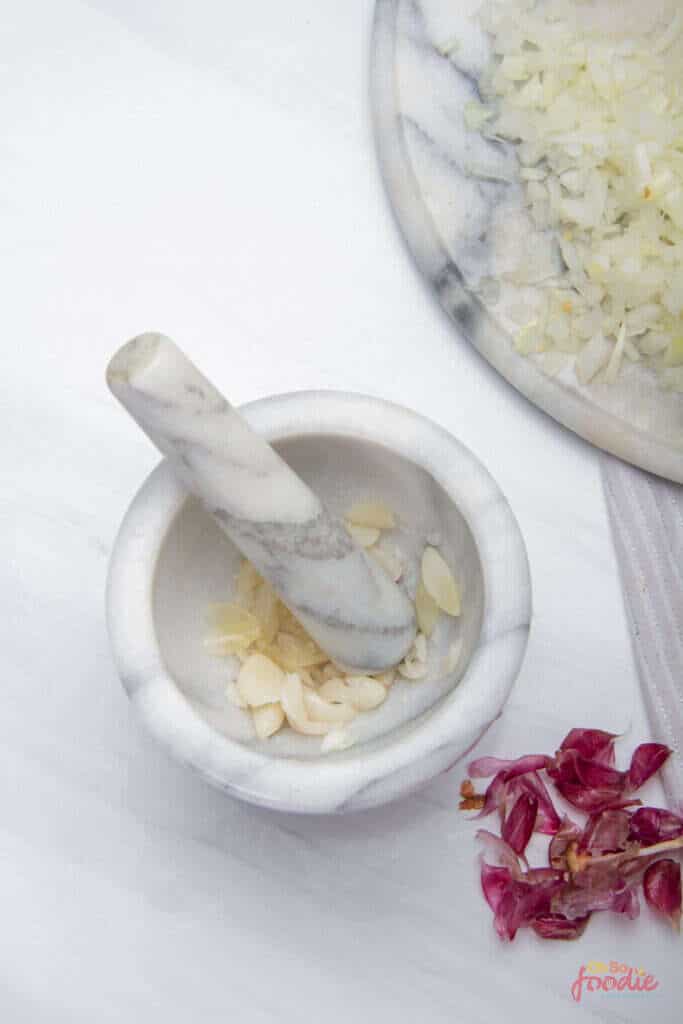 chop onions and minced garlic for seafood sauce