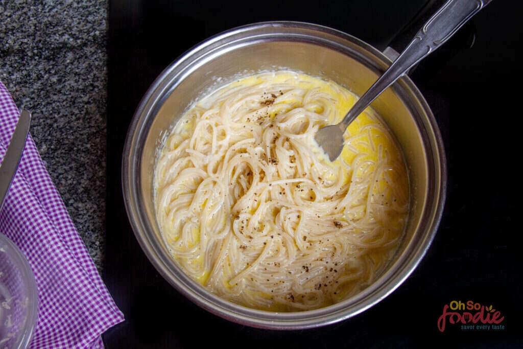 adding pasta to pasta sauce made with milk